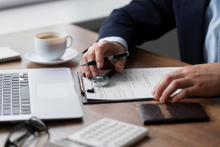 man signing document